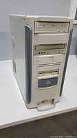 Front and side view of the vintage beige multimedia computer tower showing all drives and case condition