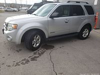 Right front three-quarter view showing silver paint, alloy wheels and running boards.