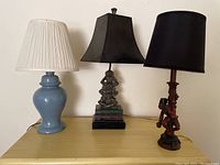 Three table lamps displayed side by side, showing the base styles and shades clearly.