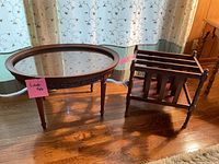 Wide view of furniture set showing oval glass tabletop and magazine rack