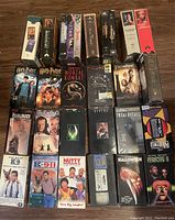 Full lot of 16 VHS movie tapes showing front covers of various popular movies.