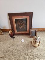 Full view of all four decorative items including framed lion picture, globe, wooden frame, and candle holder.