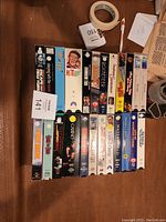 Photo showing a box with a variety of VHS movie tapes including Bonk III, Clint Eastwood movies, and others.