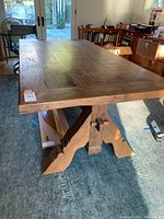 Three-quarter view of full table showing tabletop and trestle base