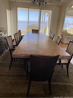 Rectangular wood table top and chairs from end view