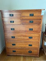 Front view of full tall dresser showing 8 drawers and black metal pulls
