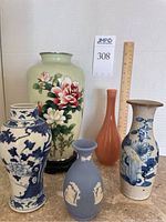 Overview of all five vases arranged with ruler for scale