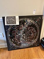 Framed celestial map with attached pamphlet showing northern hemisphere sky.