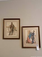 Two framed Civil War themed watercolor prints hanging on a wall, showing artillery and navy soldiers.