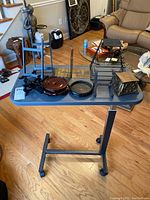 Photo showing full table with all items arranged on top, including art stands, bookends, candle holders, and desk organizer.