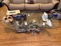 Wide front view showing the full glass top shape and driftwood base