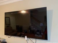 Front view of mounted 65-inch screen and bezel