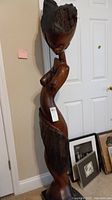 Full front view of tall wooden sculpture