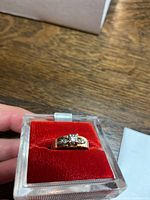 Top view of the ring in red velvet insert showing center and accent diamonds