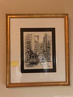 Framed print depicting a San Francisco street scene with cable car, signed by Don Davey.