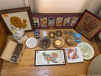 Overhead view of full lot including plates, art, books, teacup set, napkins