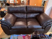 Front view of loveseat showing overall condition and design.