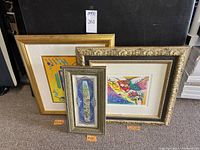 Three framed wall art pieces displayed together