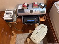 Overview of printer with ink cartridges, digital frame, and wood bench.