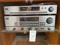 Sony stereo equipment showing the front panels of the tuner and amplifier stacked on a shelf, highlighting the buttons, digital displays, and knobs.