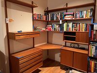 Front view of entire modular desk and shelving system with books