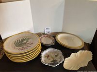 Photo displaying the Waterford bowls with gold trim near other dishes, some with gold rims including a Lenox dish.