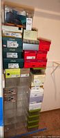 Stacked shoe boxes mostly from Clarks, Aero, and other brands with some shoe organizer boxes stacked underneath.