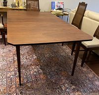 Angled view showing full table length and leaf inserted