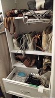 Shelf with multiple purses and handbags in neutral colors and patterned fabric tote bags