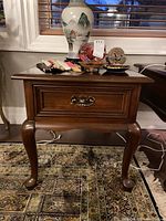 Front view of solid cherry side table showing single drawer and cabriole legs