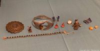 Overview of all ten pieces on display against blue cloth