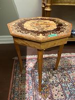 Full view of the octagonal occasional table showing overall design and wood legs.