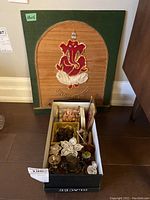Full lot showing the wooden board with red Ganesha figure and shoebox with assorted items