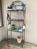Full view of the metal baker's rack with items on the shelves for staging only