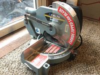 Front view of Delta power miter saw showing overall condition and blade.