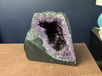 Front view of amethyst geode showing full exterior and interior cavity
