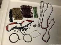 Full lot of beaded jewelry including multiple bracelets and necklaces on white background