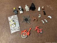 Overview of all included LEGO minifigures and accessories on flat surface