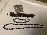 Complete jewelry set including bracelet, necklace, and pearl stud earrings on card