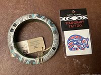 Haida wood bracelet with attached tag and Native Accents temporary tattoo pack