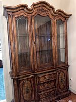 Full front view of Stanley china cabinet showing glass front upper section with shelves and wood lower section with drawers and doors