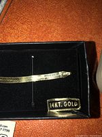 14k gold flat herringbone chain in black box stamped '14KT. GOLD'