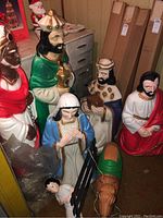Photo showing several of the nativity scene statues including Mary, Joseph, three Wise Men, baby Jesus, and a child figure.