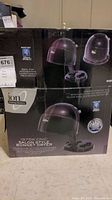 Photo of the boxed Ion 1875W Ionic Salon Style Bonnet Dryer showing product image and branding on the box.