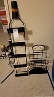 Metal hanging wine rack and Twinings metal tea rack side by side on floor