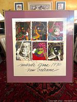 Framed poster showing six colorful portraits of Mardi Gras kings, with artist signature and numbering visible, mounted in purple matting and light wood frame.