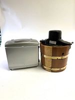 Wide shot showing both the Sterling ice cream maker with wooden bucket and the Sharper Image Hot & Cold Snack Box side by side on a white background.