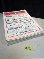 Stack of twenty Illustrated London News magazines viewed in profile showing thickness and condition of spine and pages.