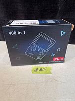 Box front showing 400 in 1 digital handheld game system Plus edition with graphic of console.
