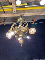Fixture mounted and lit, overhead view showing all five bulbs and overall form